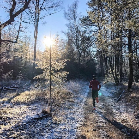 Woman running not cycling on a snowy trail